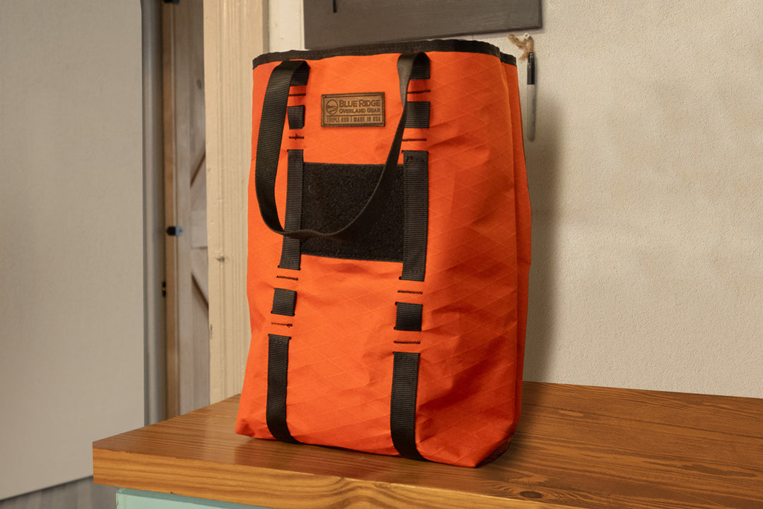 Orange X-Pac Market Tote bag by Blue Ridge Overland Gear pictured in a health food store.