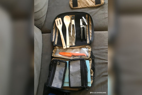 Customer-submitted photo of a BROG Tool Bag open indoors with clear-front pouches organizing kitchen utensils.