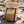Coyote Brown backpack on a wooden platform with a natural landscape in the background