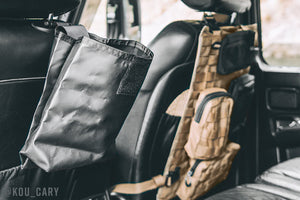 Roll up dump pouch hanging off back of driver headrest.