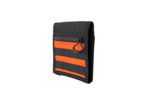 Black and orange mole visor panel with a zipper on a white background