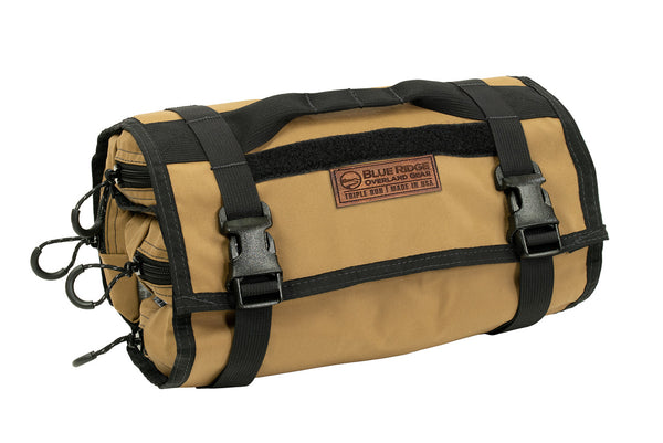 Coyote BROG Tool Pouch Roll rolled and secured with adjustable buckle straps, featuring a carry handle, leather Blue Ridge Overland Gear patch, and zippered pouches.