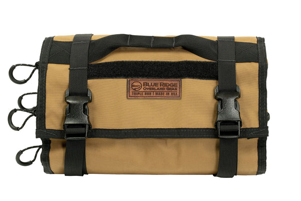 Coyote BROG Tool Pouch Roll rolled and secured with two adjustable buckle straps, carry handle, leather Blue Ridge Overland Gear patch, and multiple zipper pulls.