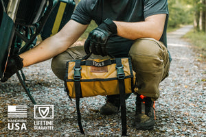 BROG Tool Pouch Roll opened across a vehicle engine bay with removable clear zippered pouches and assorted hand tools laid out for easy access.