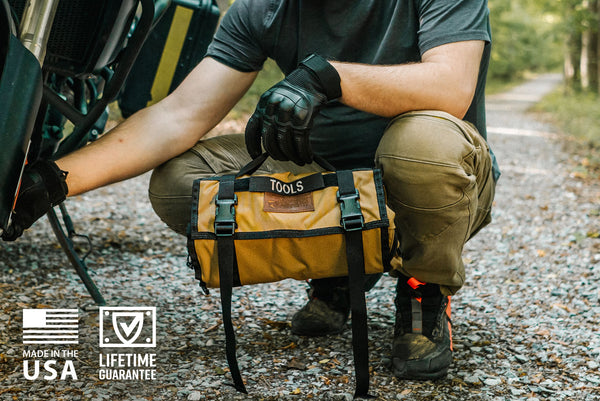 BROG Tool Pouch Roll opened across a vehicle engine bay with removable clear zippered pouches and assorted hand tools laid out for easy access.