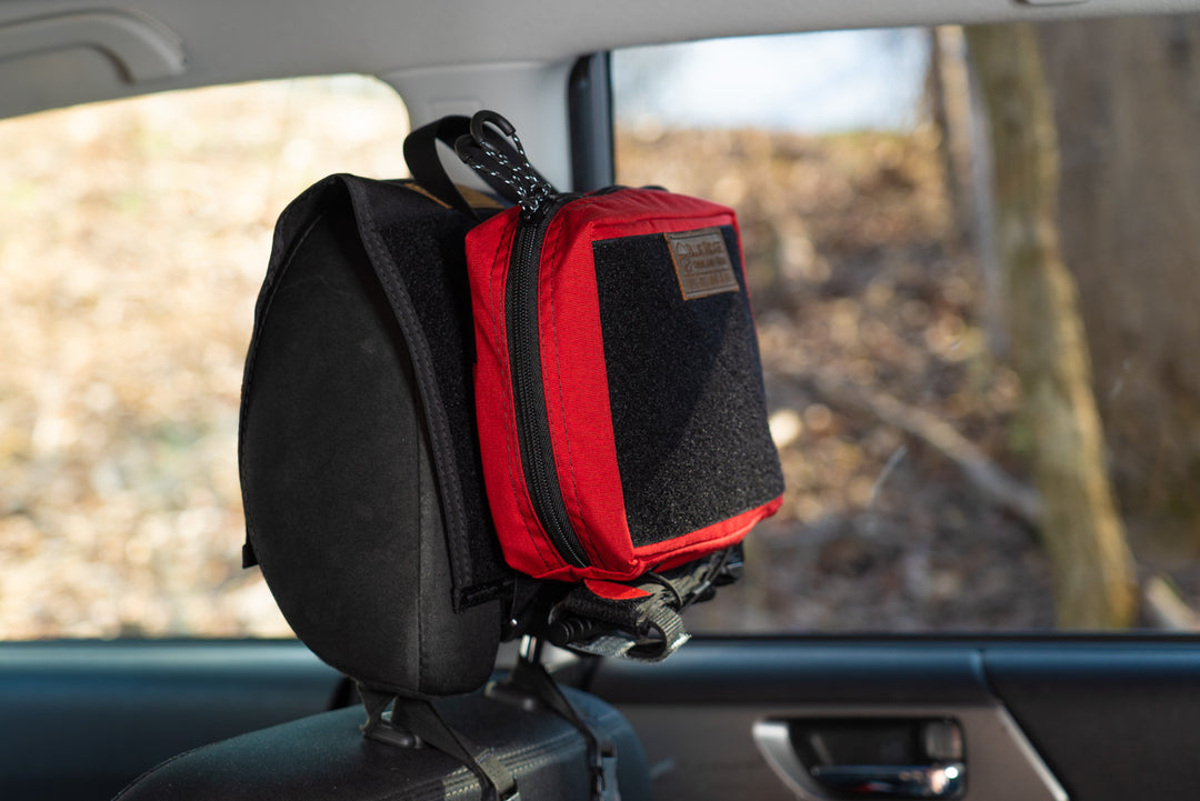 IFAK Velcro Pouch 2.0 - Small, on headrest in vehicle, side view