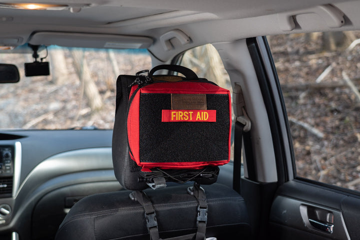 Small IFAK 2.0 - attached via Headrest Panel in vehicle, with First Aid velcro label