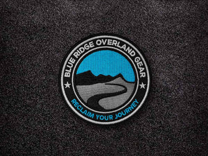 Blue Ridge Overland Gear Morale Patch stuck to Velcro. It says Reclaim your Journey across the bottom