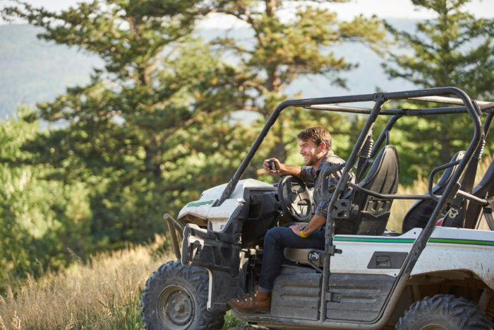 MXT115 15-Watt TWO-WAY GMRS RADIO being used in a utv in a wooded outdoor setting