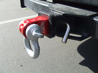 Factor 55 | HitchLink 2.5 Receiver Shackle Mount Assembly installed in a 2.5" hitch receive with a bow shackle attached to it. 