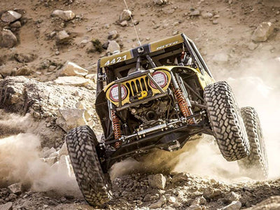 FACTOR 55 FlatLink Low Profile Shackle Mount on rock buggy jumping off  a rock