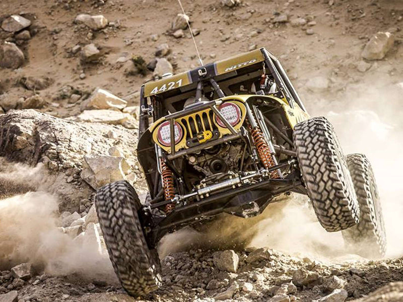 FACTOR 55 FlatLink Low Profile Shackle Mount on rock buggy jumping off  a rock