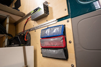 Pouch Mounting Panel 12x12" Shown mounted to the inside wall of a van with three pouches attached.