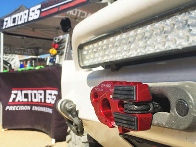 FACTOR 55 UltraHook in red, mounted to a winch on the bumper of a toyota, right under a light bar.